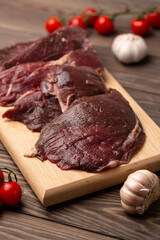 Raw fresh roe deer meat, fillet on a cutting board