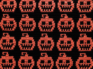 Orange black crochet Halloween background. Seamless mosaic crochet pumpkin fabric.