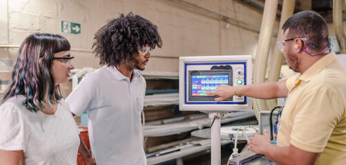 technician from an industry explaining to students from a technical school how the application of a...