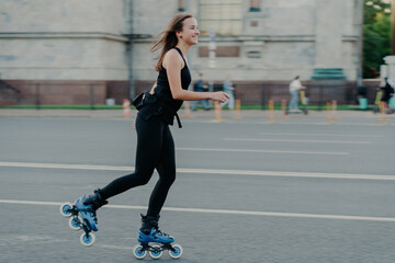Rest leisure and lifestyle concept. Cheerful dark haired young European woman breathes fresh air...