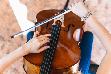 Fototapeta premium Antique Cello Inspiring the Melodic Journey of a Young Musician