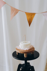 White bento cake for first baby birthday. Birthday girl or boy party decorations. Cake smash