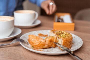 Croissants with Pistachio cream and morning coffee on background