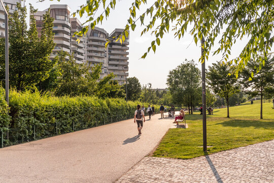 People walking at sunset in summer, in the park of Milano CityLife district, Milano, Italy. 