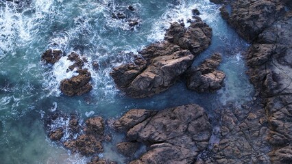Aerial view of an idyllic landscape with a body of water and rocky outcrops