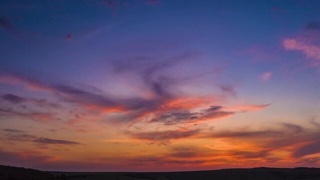 Time-lapse of the beautiful pink and blue clouds in the sky during the  golden sunset