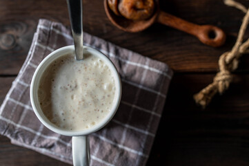 Yogurt with dried figs in a cup with spoon