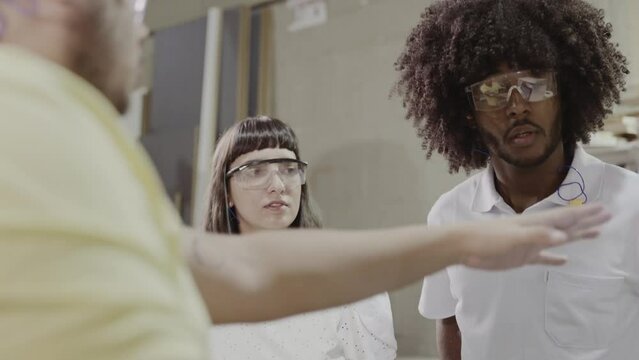 professor de um curso de tecnologia no Brasil mostrando para os alunos as opcoes de programacao no painel digital da maquina