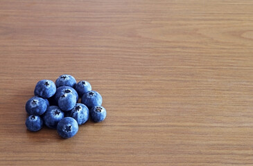 Blueberries on a wooden table. Space for text