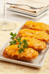 Toasts with melted cheddar cheese