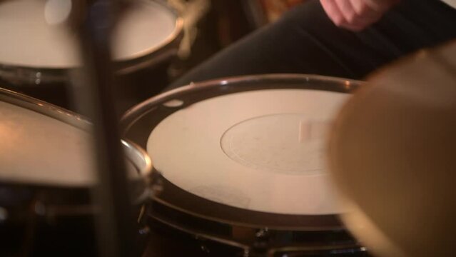 Session drummer recording some rock beats in the studio