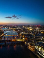 Aerial view of the London skyline illuminated during blue hour, United Kingdom.