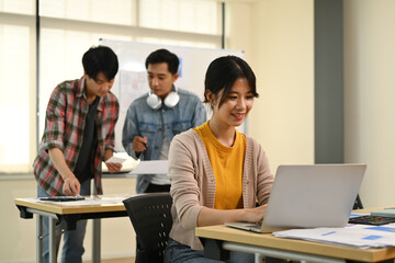 Developer team collaborating and planning template layout for mobile application in office