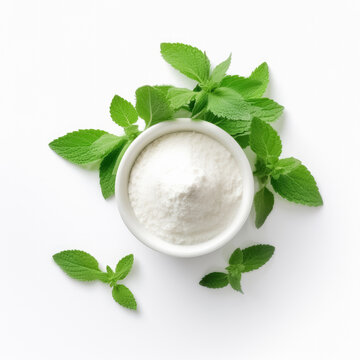 Stevia powder with green plant, in a bowl, isolated on white background, top view,