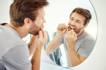Dental floss, morning and mirror with man in bathroom for self care, oral hygiene and teeth....