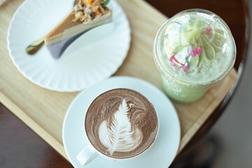 Top view of a white ceramic tray full of freshly prepared cake and beverages
