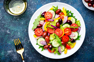 Tasty salad with kalamata olives, tomatoes, paprika, cucumber and onion, healthy mediterranean...