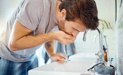 Man in bathroom, brushing teeth and rinse with water, morning cleaning routine for health and...