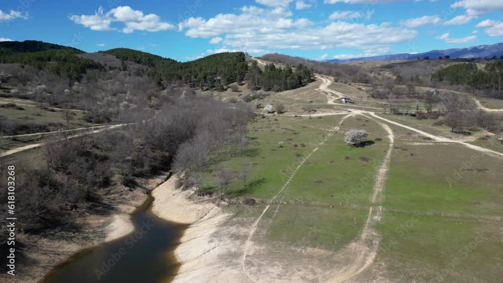 Poster drone scene over a lake with fields and trees and green vegetation trees mountains in the summer