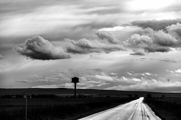 Dramatic grayscale shot of a field under a cloudy sky in Kakheti, Georgia.