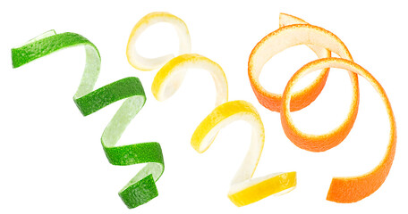 Fresh peel of lemon, orange and lime fruit isolated on a white background. Citrus zest spirals.