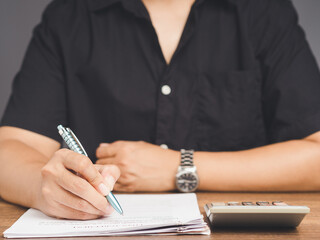 Businessman signing a lease contract or agreement while sitting at the table in the office.
