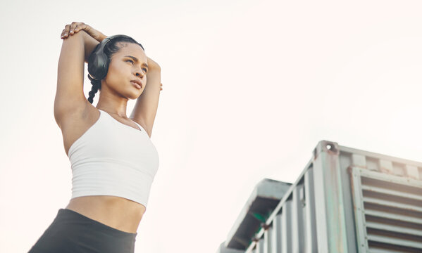 Exercise, city and woman with headphones, fitness or wellness with training, podcast and stress relief. Female person, runner or girl with headset, streaming music and radio with progress and workout