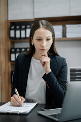 business woman working at office with laptop and documents on his desk, financial adviser analyzing data.