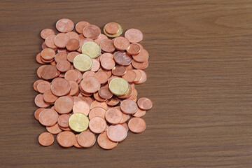 Euro coins on a wooden table. Space for text.