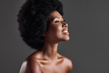 Hair, smile and profile of black woman with afro hairstyle, beauty and skincare on grey background....