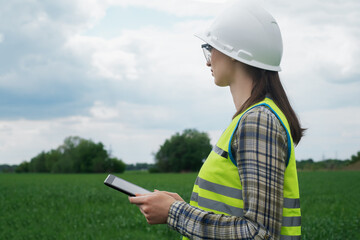 electrical engineer woman high voltage power industry, electrician worker working, energy concept, high voltage electrical tower, power line, working tablet