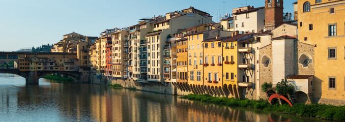 Naklejka premium Panoramic of colourful houses near the Ponte Vecchio in Florence. Italy Travel. European Travel Destination. Historic Architecture.