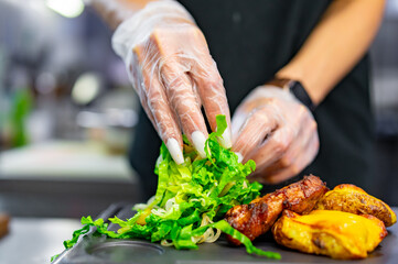 woman chef hand cooking grilled meat with baked potatoes and salad