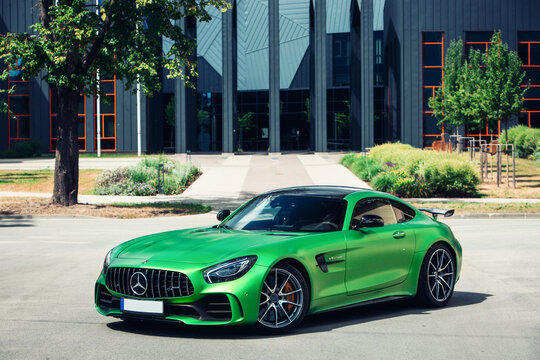 Mercedes AMG GT-R green at the parking of modern private house