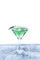 Modern green transparent cocktail adorned with lavender standing on ice bar. Isolated white background. Great design with copy space. Summer drinks concept.