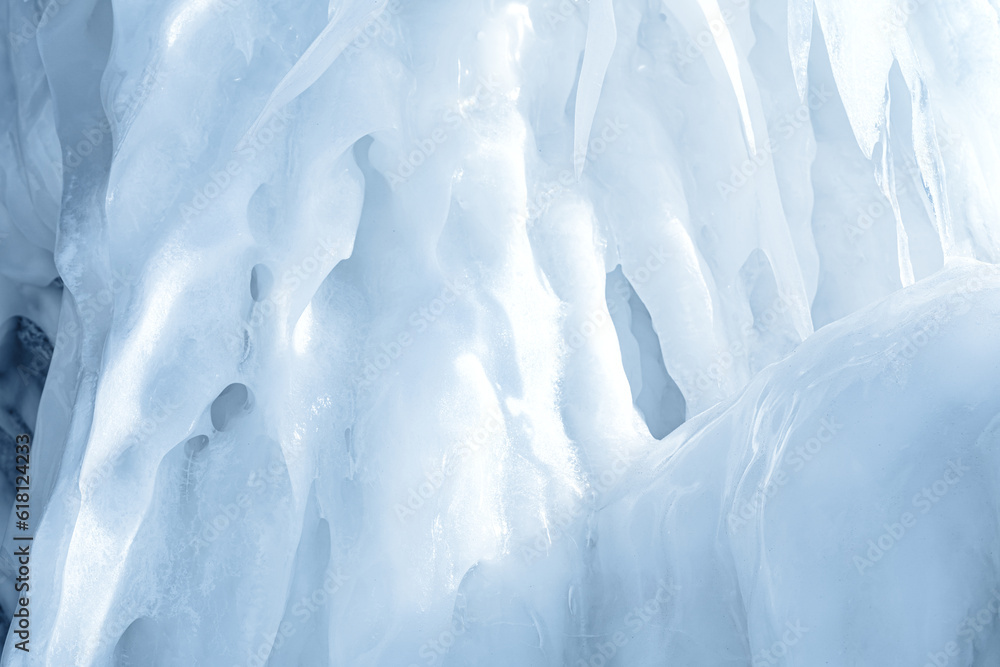 Wall mural Blue ice and icicles on the rocks of Ogoy island, Baikal lake, Siberia, Russia. Abstract winter nature background with copy space.