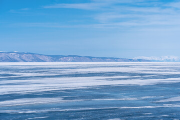 Winter landscape with mountains and Lake Baikal in Siberia on sunny day. Natural background with copy space.