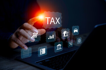 Businessman using laptop to fill in the income tax online return form for payment.business using...