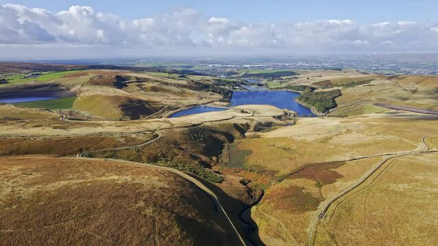 Aerial drone, cinematic footage of a valley with 3 lakes reservoirs, piethorn, kittcliffe and ogden reservoir, Oldham