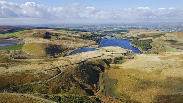 Aerial drone, cinematic footage of a valley with 3 lakes reservoirs, piethorn, kittcliffe and ogden reservoir, Oldham