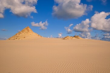 Beautiful holiday seaside landscape. Moving dunes in the desert in Slowinski National Park in Leba, Poland. - obrazy, fototapety, plakaty
