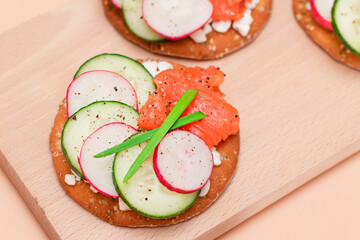 Crispy Cracker Sandwiches with Fresh Salmon, Cucumber, Radish, Cottage Cheese and Green Onions. Easy Breakfast. Quick and Healthy Sandwiches. Crispbread with Tasty Filling. Healthy Dietary Snack
