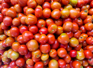 Tomatoes in the market. Red tomatoes on a counter in the market