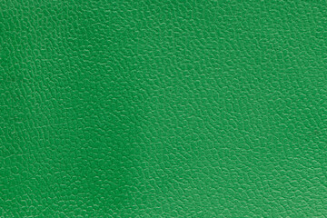 Green artificial leather with large texture. Artificial skin. Close-up. Background. Texture.