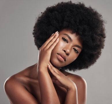 Black woman, portrait and hands touching face, natural beauty and afro hair with glow on studio background. African female model, cosmetic care and healthy skin, facial and shine with skincare