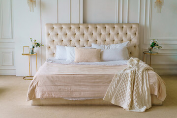 Fototapeta na wymiar beautiful bed with pillows and a blanket in pink and white colors, delicate interior