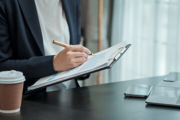 Young business woman lawyer works in office, bookkeeping, audit, stock split, accounting valuation,...