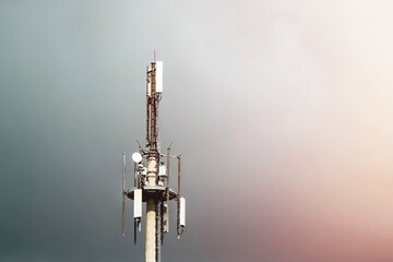 Telecom Tower 5G and 4G Cellular Networks in the sky. cell tower over a forested rural area