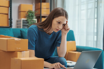 Startup small business entrepreneur SME or freelance woman using a laptop with box, Caucasian woman seller prepare parcel box of product for delivery to customer Online selling e-commerce SME concept