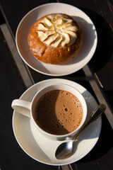 Cup of coffee and cake. Bun with cottage cheese. Morning. Cappuccino. Hot drink. Breakfast.